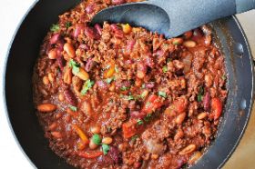 Chili con carne, meaning "chili with meat", is a spicy stew containing chili peppers, meat, tomatoes and often pinto beans or kidney beans. Other seasonings may include garlic, onions, and cumin. The dish originated in northern Mexico or southern Texas.